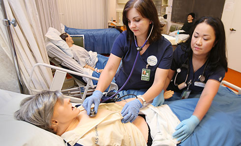 Highline College Nursing Students in classroom with als simulator manikin